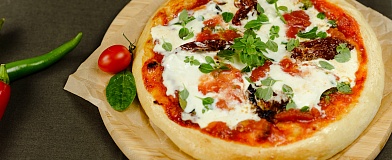 Pizza with burrata cheese, tomatoes, and spicy Kimchi Tamaki