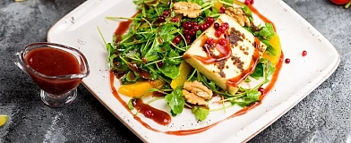 Fried halloumi cheese on a basis of arugula with Cowberry sauce Tamaki